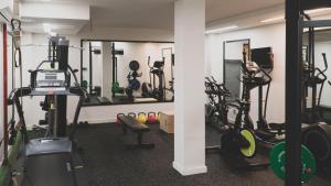 a gym with several tread machines and mirrors at Zenit Conde de Orgaz in Madrid