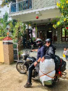 un hombre y una mujer sentados en una motocicleta en Mountain View Homestay en Thekkadi