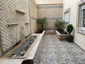 a courtyard of a building with a tub and a tile floor at Apartment in Larache Marokko in Larache