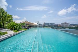 a large swimming pool on the roof of a building at Mercure Phuket Patong Journeyhub in Patong Beach
