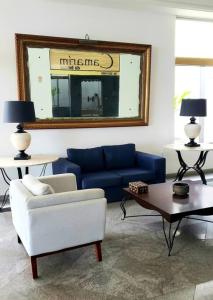 Ondina vista mar في سلفادور: غرفة معيشة مع أريكة زرقاء ومرآة