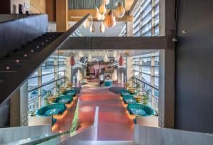 a view of a restaurant with tables and chairs at Barceló Malaga in Málaga