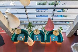 a group of pendant lights hanging from a ceiling at Barceló Malaga in Málaga