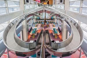 an overhead view of a library with tables and chairs at Barceló Malaga in Málaga