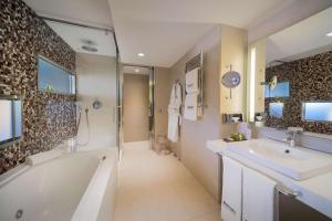 a bathroom with a tub and a sink and a shower at Barceló Malaga in Málaga