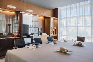 a conference room with a large table and chairs at Barceló Malaga in Málaga