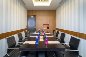 a conference room with a long table and chairs at Barceló Malaga in Málaga