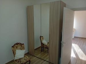 a room with a mirror and two chairs and a door at Casa del Contadino in Vittoria