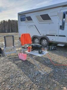 a camper with a chair and a table next to it at Husbil centralt in Kalmar