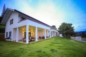 a large white house with a large yard at Benito Bungalow by The Serendipity Collection in Haputale