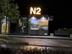 a sign on the side of a street at night at Largo da Fonte in Sertã
