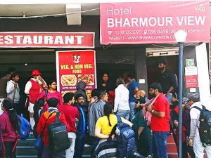 a crowd of people standing outside of a restaurant at Hotel Bharmour View in Brāhmaur +1 photo