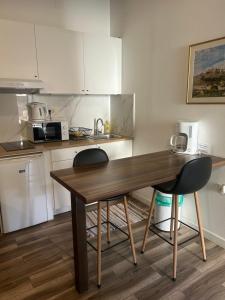 a kitchen with a wooden table and two chairs at Elena Rooms Split in Split +3 photos