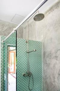 a shower in a bathroom with a green tile at Boutique Jungle Villa - Baan ChaOm in Ko Lanta