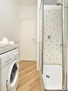 a washing machine in a bathroom with a shower at MARCONA 1 - City Centre Apt with Terrace in Milan
