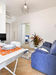 a living room with a blue couch and a table at MARCONA 1 - City Centre Apt with Terrace in Milan