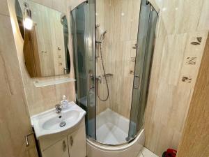 a bathroom with a shower and a sink at City & Sea - Apartamenty i Mieszkania in Gdynia
