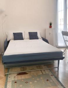 a bed in a living room with a mattress at MARCONA 1 - City Centre Apt with Terrace in Milan