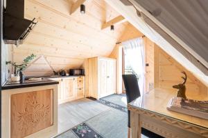 a kitchen in a wooden cabin with a counter at Highlander Heart Residence in Zakopane
