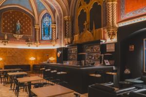 a bar in a restaurant with tables and chairs at Zenit Convento San Martin in Donostia-San Sebastián