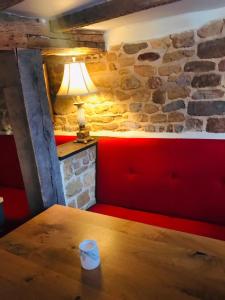 Zimmer mit einem Tisch und einer Ziegelwand in der Unterkunft The Three Pigeons Inn in Banbury
