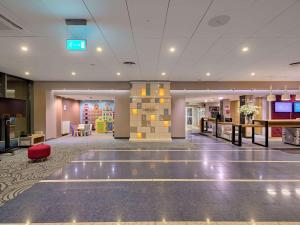 a lobby of a hotel with a waiting area at Mercure Gdańsk Posejdon in Gdańsk