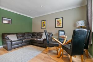 a living room with a couch and a table and chairs at 5 St Georges House Lovely 1-Bed Apartment Right in the Heart of York Pass the Keys in York