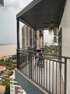 a balcony with a table and a view of a city at 1 Bedroom - 1Bath Unit, with Balcony, River View in Phnom Penh