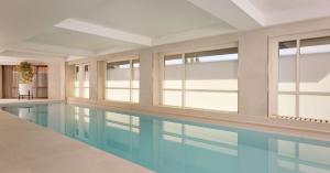 a swimming pool in a building with windows at Park Plaza London Riverbank in London