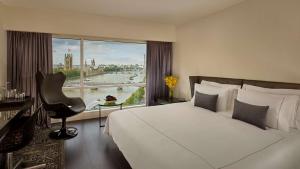 a hotel room with a bed and a large window at Park Plaza London Riverbank in London +37 photos