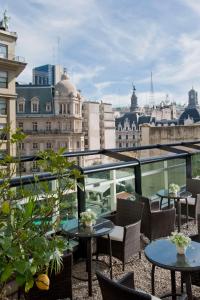 a balcony with tables and chairs and a view of the city at NH Collection Buenos Aires Centro Histórico in Buenos Aires