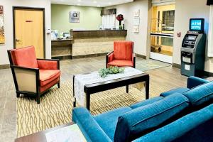 a waiting room with a couch and chairs in a pharmacy at Quality Inn & Suites by Choice Hotels Wisconsin Dells in Wisconsin Dells