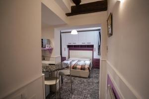 a small room with a bed and a desk and a kitchen at San Polo Studio in Venice