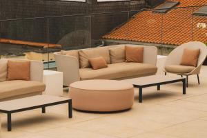 a living room with a couch and two chairs and tables at Zenit Convento San Martin in Donostia-San Sebastián