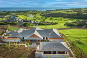 an aerial view of a house with a golf course at Kauai Luxury Vacation Villas in Koloa