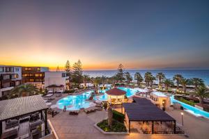 uma vista aérea de um resort com piscina e oceano em D'Andrea Mare Beach Hotel em Ialyssos