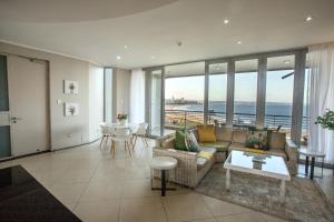 a living room with a view of the ocean at Stay at The Point - Magnificent Magical Marvel in Durban