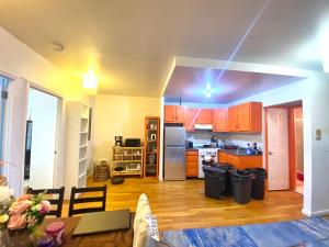 a kitchen with orange cabinets and a kitchen with a table at # 2 Charming Queen Bed - Shared Room - Business Travel! By Zen Living Short Term Rental in Brooklyn