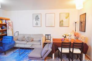 a living room with a couch and a table at # 2 Charming Queen Bed - Shared Room - Business Travel! By Zen Living Short Term Rental in Brooklyn