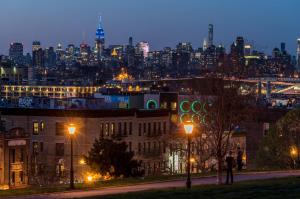 a view of a city skyline at night at # 2 Charming Queen Bed - Shared Room - Business Travel! By Zen Living Short Term Rental in Brooklyn