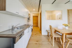 a kitchen and dining room with a wooden table at Käferberghof 