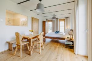 a bedroom with a table and chairs and a bed at Käferberghof 