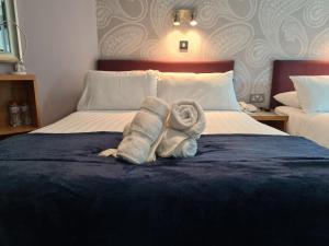a hotel room with a bed with towels on it at Jackson Court Hotel in Dublin