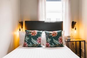 um quarto com uma cama com duas almofadas e uma janela em CitySpace Borough em Londres
