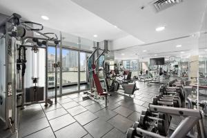 a gym with treadmills and machines in a building at Cozy Dubai Marina Design Studio close to Jumeirah Beach, Mall & Metro in Dubai