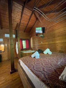um quarto com uma cama num quarto de madeira em Itamar Cabins em Had Nes