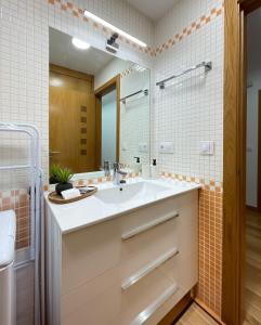 a bathroom with a sink and a mirror at Las Terrazas de Vigo in Vigo