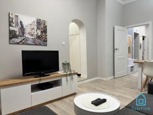 a living room with a flat screen tv on a cabinet at Anchor Apartment in Gdańsk