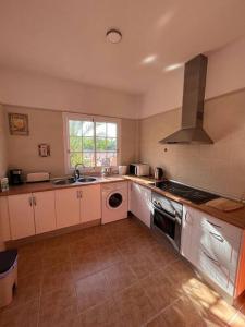 a kitchen with a sink and a dishwasher at Chalet piscina privada max 26º Jardín, tranquilidad in Garachico +47 photos