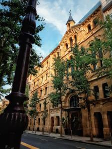 a street pole in front of a large building at Zenit Convento San Martin in San Sebastián